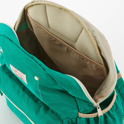 Green baby carrier with beige interior on a white background